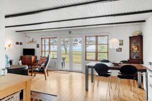 a living room with a dining room table and chairs at 80262-Vemb-Hyttevej-103 in Skalstrup