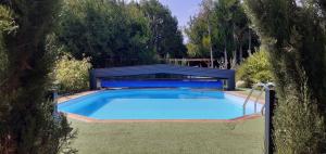 a swimming pool in a yard with a fence around it at Au P'tit Versailles in Châtillon-sur-Seine