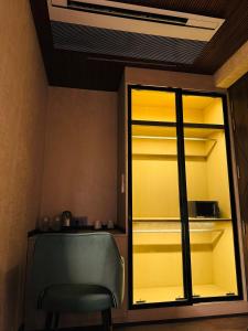 a room with a chair and a glass closet at Dream Stay in Ghaziabad