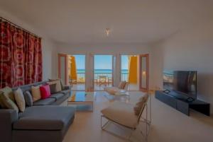 a living room with a couch and a television at Luxury Stays in New Marina, El Gouna in Hurghada
