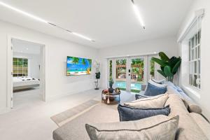 a living room with a couch and a table at Family Fun Haven Pool, Mini Golf and More L78 in Miami