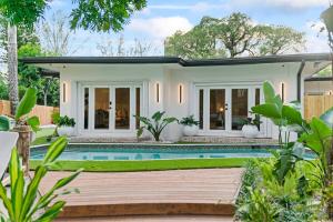 a house with a swimming pool in front of it at Family Fun Haven Pool, Mini Golf and More L78 in Miami