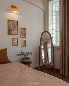 a bedroom with a bed and a mirror at AiCi Home in Da Nang