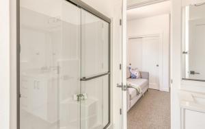 a glass shower door in a bathroom with a couch at Harbor Lights 4 - Whale Watcher's HavenFamily Fun in Depoe Bay +44 photos