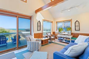a living room with a blue couch and chairs at 5237 - Carpe Dune in Croatan Shores +49 photos