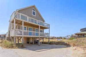 a house with a wrap around deck on a beach at 5237 - Carpe Dune in Croatan Shores