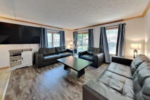 a living room with a couch and a tv at Island Club #111 in Put-in-Bay