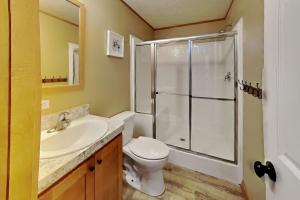 a bathroom with a shower and a toilet and a sink at Island Club #111 in Put-in-Bay +20 photos