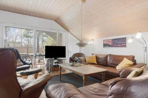 a living room with a couch and a table at 30051-Ulfborg-Snerlevej-483 in Vang