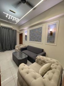 a living room with a couch and a table at Premium 2BHK Stay Spacious Stylish in Noida in Noida