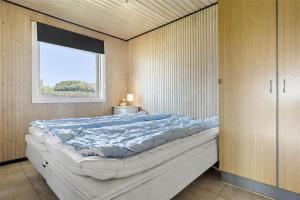 a large bed in a room with a window at SL203-Slagelse-Strandvaenget-46 in Slagelse