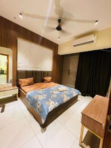 a bedroom with two beds and a ceiling fan at Premium 2BHK Stay Spacious Stylish in Noida in Noida