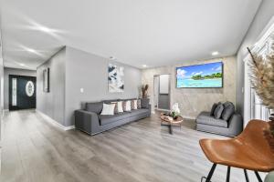 a living room with two couches and a tv at 5BR Game Retreat Pool, Mini Golf and Firepit L86 