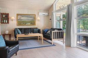 a living room with a couch and a table at 30816-Ulfborg-Oster-Skovvej-67 in Vang