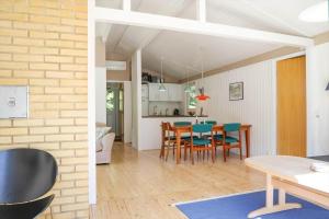 a kitchen and dining room with a table and chairs at 13356-1-Hojby-Harpevej-32 in Gudmindrup