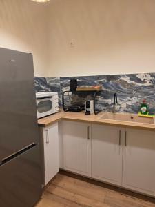 a kitchen with a sink and a microwave at Kos central vibes - Villa Vasiliki in Kos