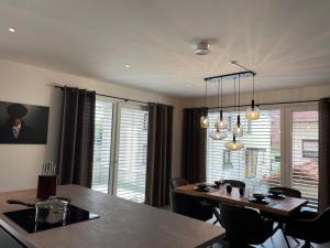 a kitchen and dining room with a table and chairs at Ferienwohnung Nostalgic In der Nähe von Sinsheim Apartmenthaus Traudl in Zuzenhausen +10 photos