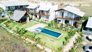 an aerial view of a house with a swimming pool at Ap superior Amanita Kite Home - vista mar piscina in Ponta do Anel