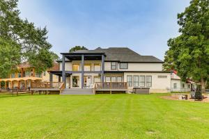a large house with a large yard at Dock and Hot Tub! High-End Cedar Creek Lake Retreat in Gun Barrel City