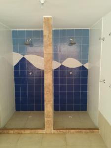 a bathroom with a shower with blue tiles at Apto 501 E Alto del Fonce in San Gil