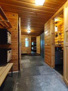 a hallway in a log cabin with a kitchen at Log cabin Ylläs Valokki - sauna, fireplace, Ylläs view in Ylläsjärvi