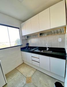 a small kitchen with a sink and a window at Ap Knots - 6x S/ Juros- vista mar- hidro in Ponta do Anel +12 photos