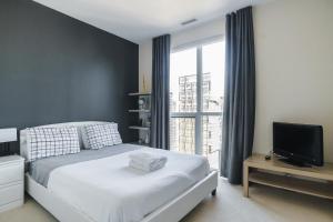 a bedroom with a bed and a tv and a window at The One in Toronto +178 photos