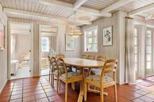 a dining room with a table and chairs at 10858-Ulfborg-Raketvejen-41 in Øhuse