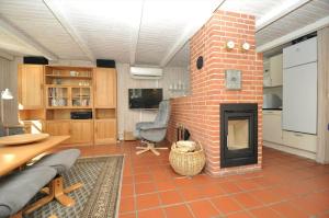 a living room with a brick fireplace in a room at 10858-Ulfborg-Raketvejen-41 in Øhuse +15 photos