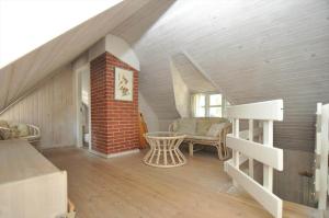 a attic room with a staircase and a table at 10858-Ulfborg-Raketvejen-41 in Øhuse