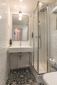 a bathroom with a sink and a shower at ibis Styles Paris Eiffel Cambronne in Paris +79 photos