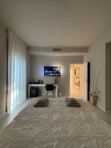 a large bed in a room with a television on the wall at Salotto Santa Franca in Piacenza