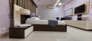 a hotel room with a bed and a tv at Spacious 2BR Portion with Rooftop Gulshan e Iqbal Block 7 in Karachi