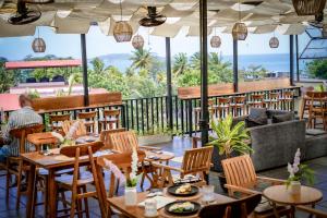 a restaurant with tables and chairs with a view of the ocean at Scenic Bay Weligama in Weligama