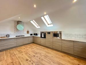 a large kitchen with wooden floors and skylights at Central duplex Apt in Leamington Spa in Leamington Spa