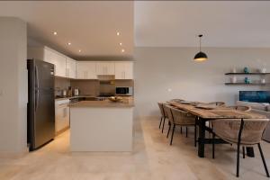 a kitchen and dining room with a table and a refrigerator at Luxury Stays in New Marina, El Gouna in Hurghada