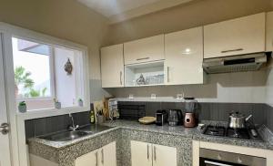 a kitchen with a sink and a counter top at Sun, Pool & Beach - Imi Ouaaddar Getaway in Agadir nʼ Aït Sa