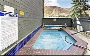 a swimming pool in a building with a sign at Elegant Escape in Park City