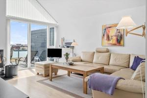 a living room with a couch and a table at 70894-Ulfborg-Skolegade-15-Lejl-6 in Thorsminde
