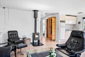 a living room with a wood stove in it at 30140-Ulfborg-Valmuevej-290 in Vang +9 photos