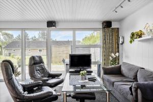 a living room with two leather chairs and a couch at 30140-Ulfborg-Valmuevej-290 in Vang