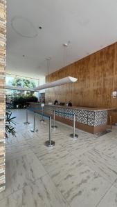 a lobby with a counter in a building at Top Apto Iloa Equipado H in Barra de São Miguel +45 photos