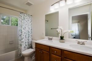 a bathroom with a sink and a toilet and a mirror at Fire Pit Funhouse 2 Master Suites Game Rm in Westminster +29 photos