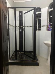 a shower with a glass door in a bathroom at Inn on Lichfield Lane in Harare