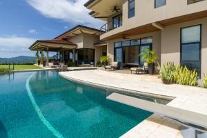 an image of a house with a swimming pool at Casa Symbiotica - Exclusive Villa with Gym, Infinity Pool & Housekeeping in Brasilito