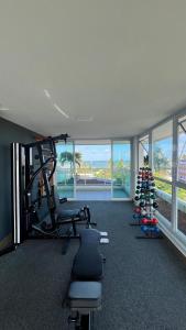 a gym with treadmills and exercise equipment in a room at Flats no Nixxus Residence (Flats da Elena) in Porto De Galinhas