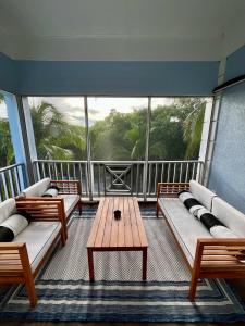 a balcony with couches and a table in a room at Townhouse Villa 5 The Village at Hoopers Bay in New Providence Island +20 photos