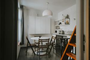 a kitchen and dining room with a table and chairs at 2 bedrooms triplex in historic heart of Liege in Liège