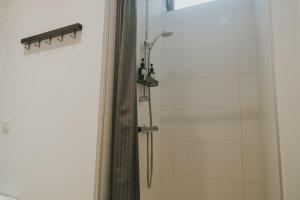 a shower with a shower curtain next to a window at 2 bedrooms triplex in historic heart of Liege in Liège