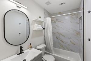 a white bathroom with a sink and a mirror at Gated 5BR Duplex Med Center Downtown NRG in Houston +25 photos